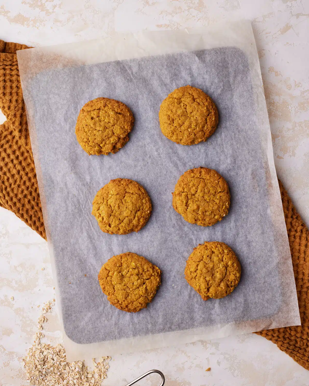 baked pumpkin oatmeal cookies on a cookie sheet. 