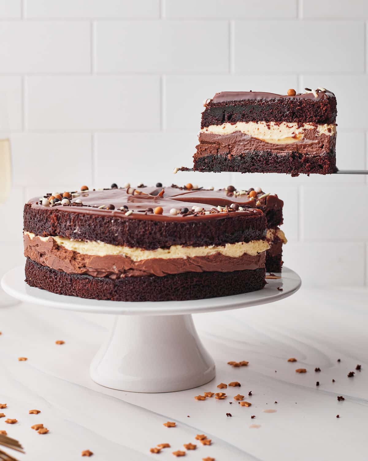 slice of tuxedo cake being lifted out of the whole cake. 