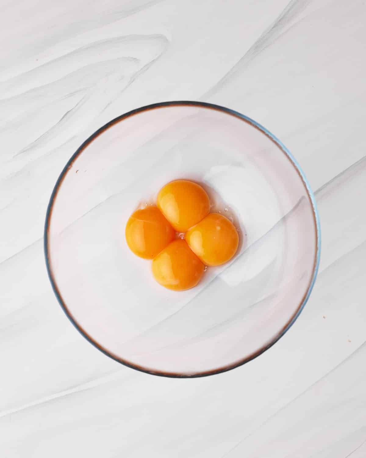 egg yolks in a bowl to make chocolate mousse for tuxedo cake.