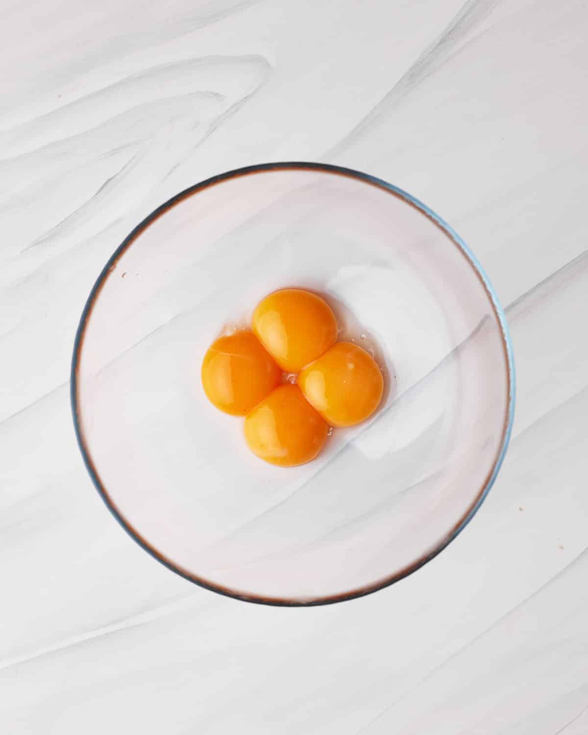 egg yolks in a bowl to make chocolate mousse for tuxedo cake. 