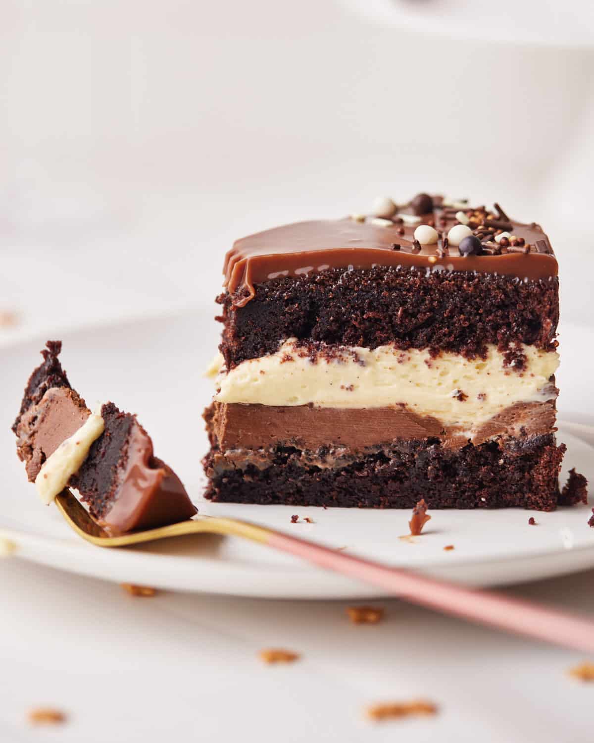 slice of tuxedo cake with a bite taken out on the fork next to it.
