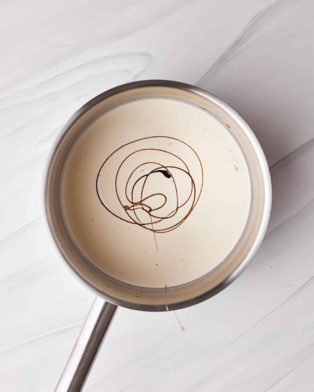 heavy cream and vanilla in a saucepan to make chocolate mousse for tuxedo cake.