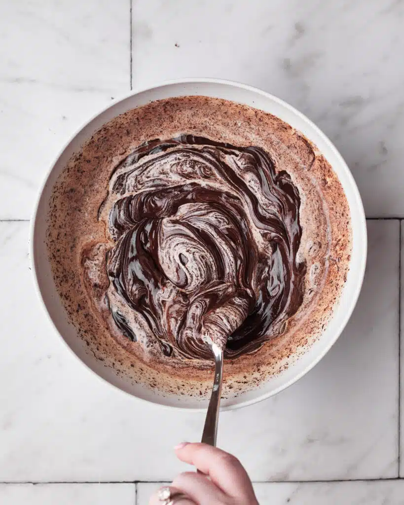 mixing warm cream into chocolate to make chocolate ganache.