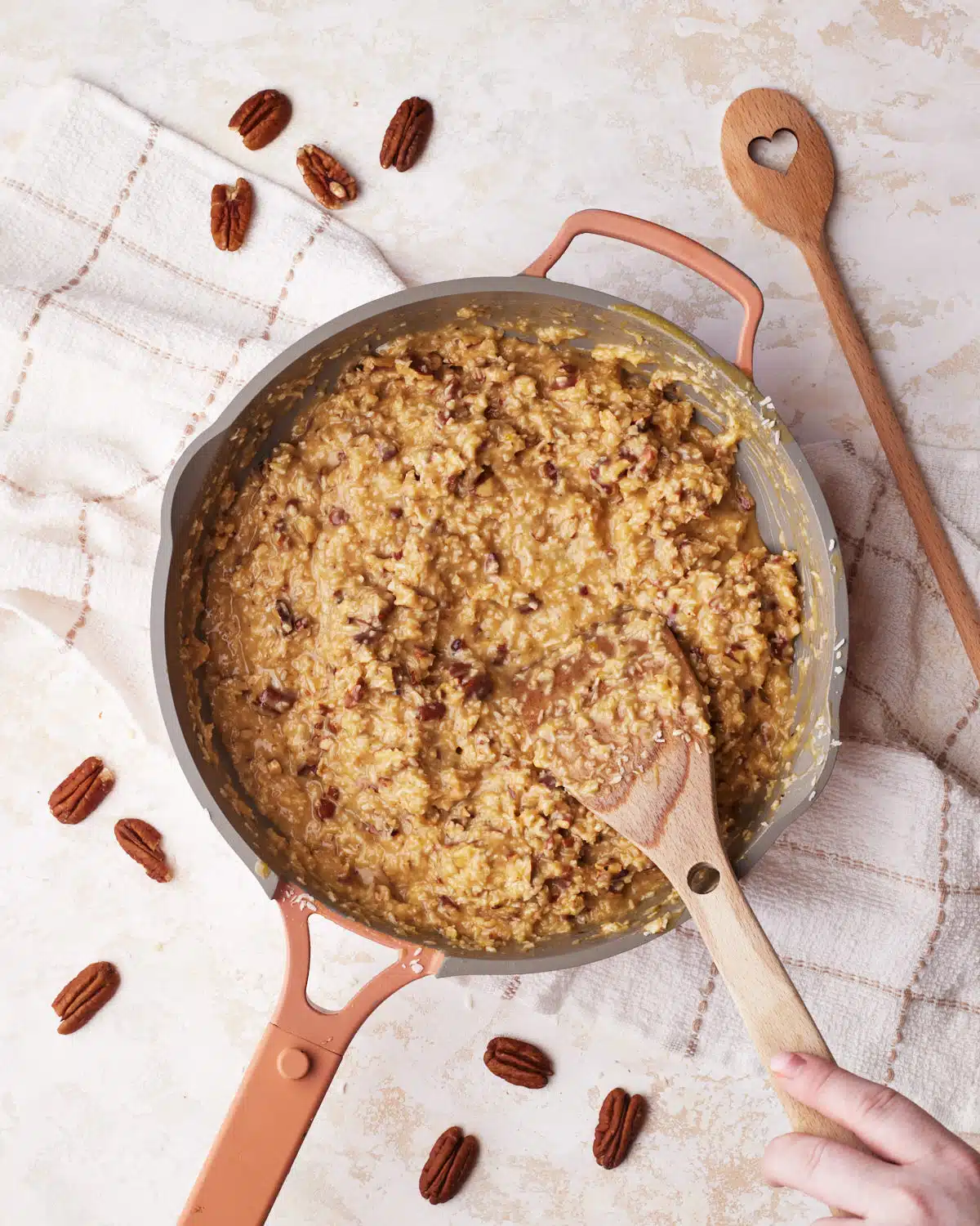 process shot of german chocolate frosting being made in a pan.