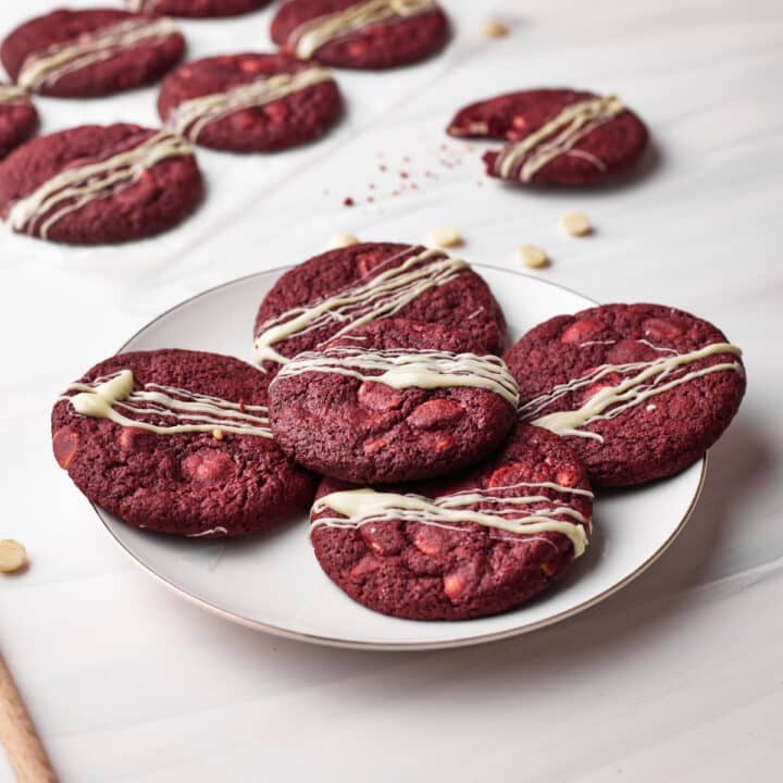 Red velvet cookies piled on a plate.