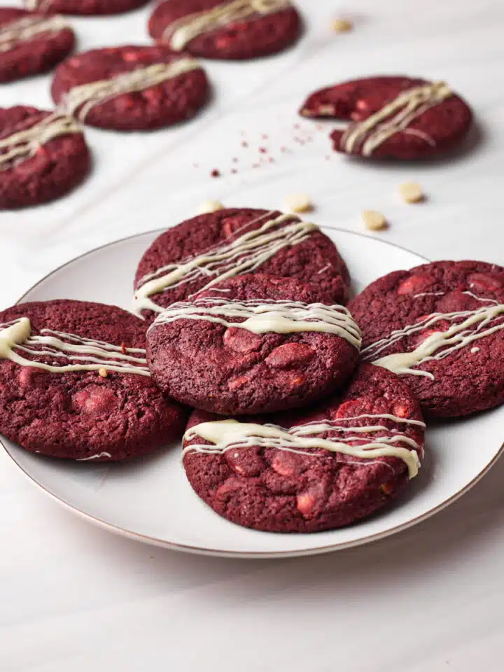 Red velvet cookies piled on a plate.