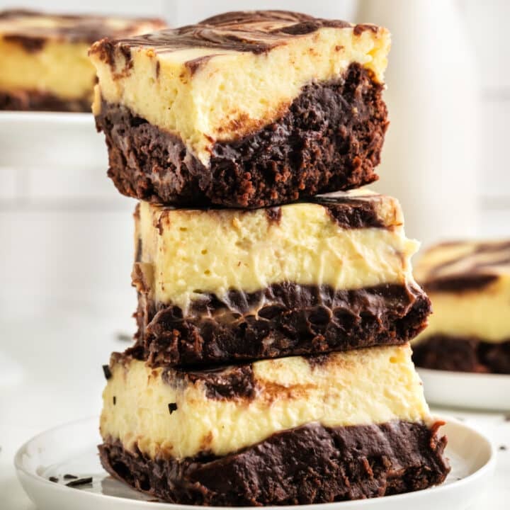 Cheesecake brownies in a stack.