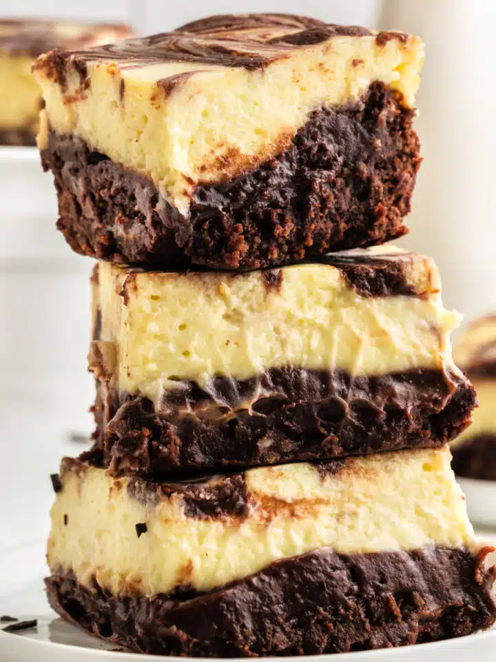 Cheesecake brownies in a stack.