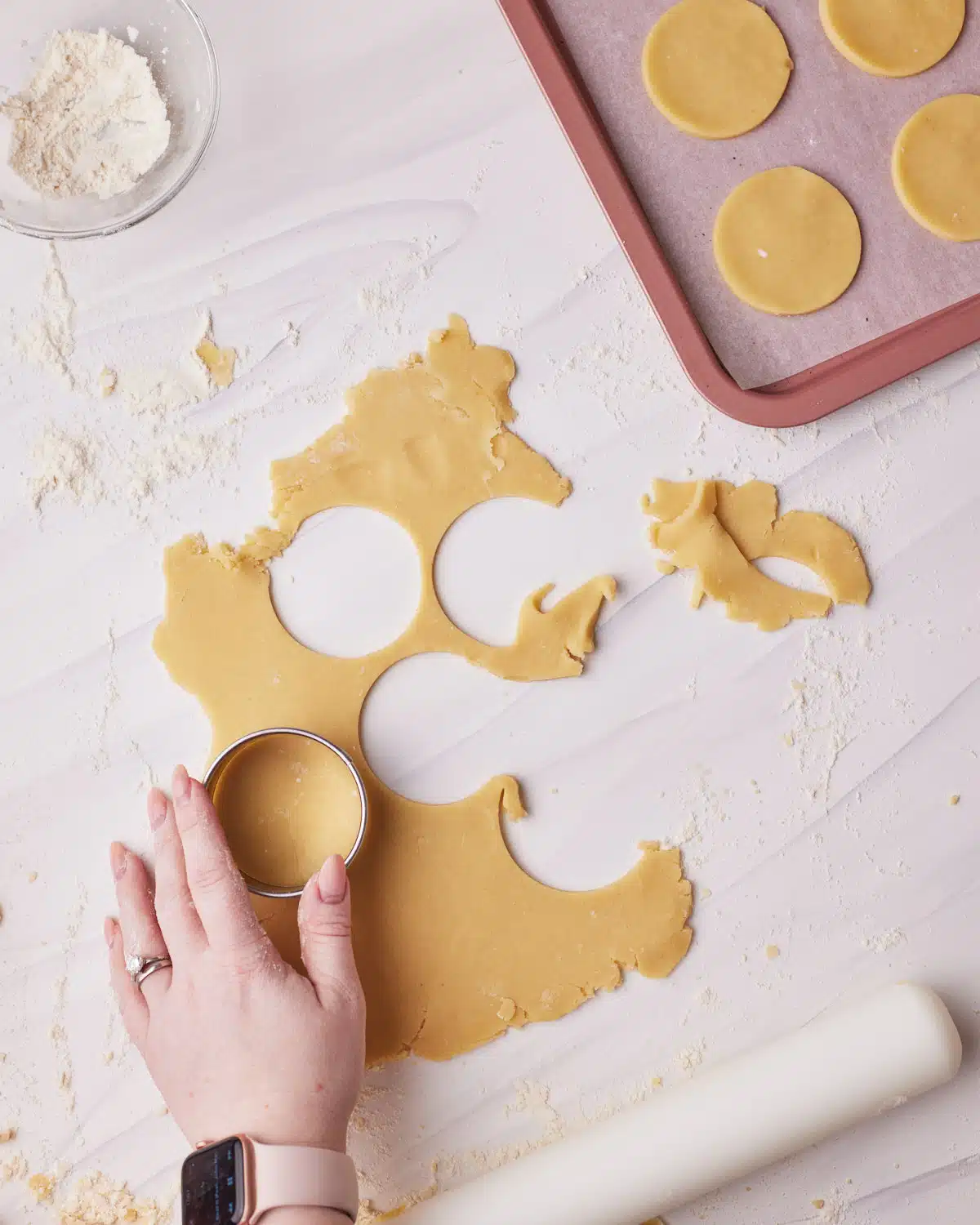 Cutting out shapes to make 3 ingredient sugar cookies. 