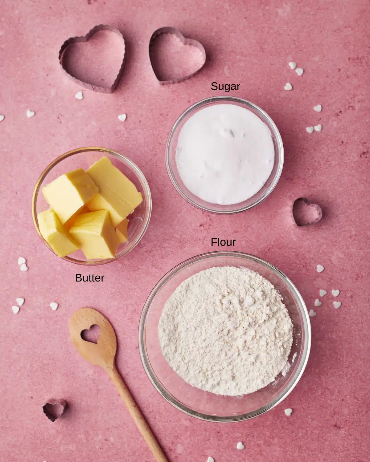 Photo of ingredients to make heart cookies for valentines day - sugar, butter and flour. 