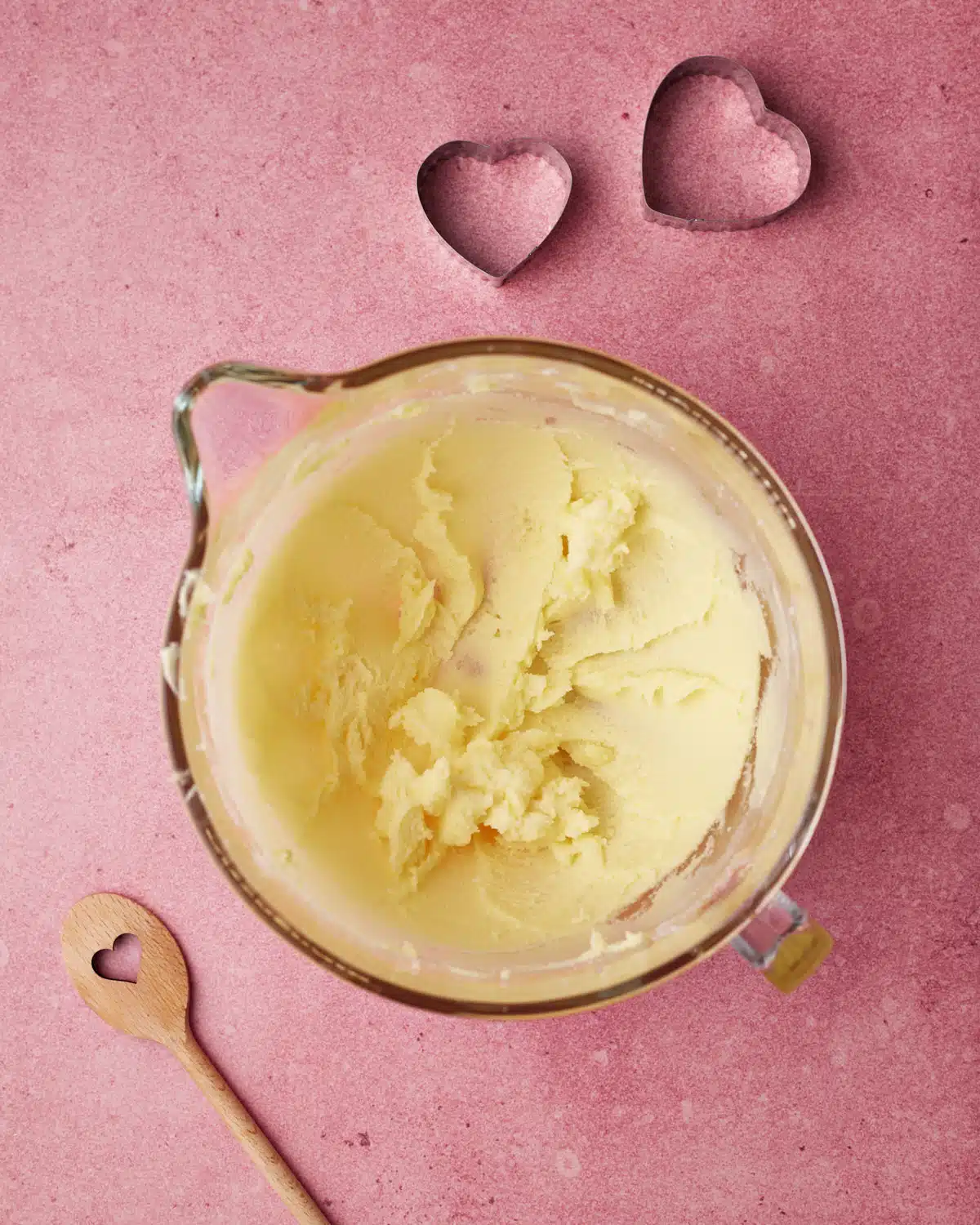 Butter and sugar creamed together to make heart shaped sugar cookies.