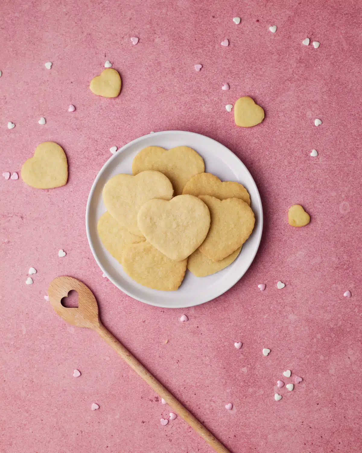 heart cookies piled on a plate. 