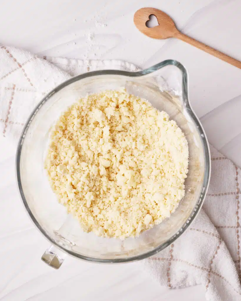 Process shot of making vanilla cupcakes - mixture looks like chunky breadcrumbs.