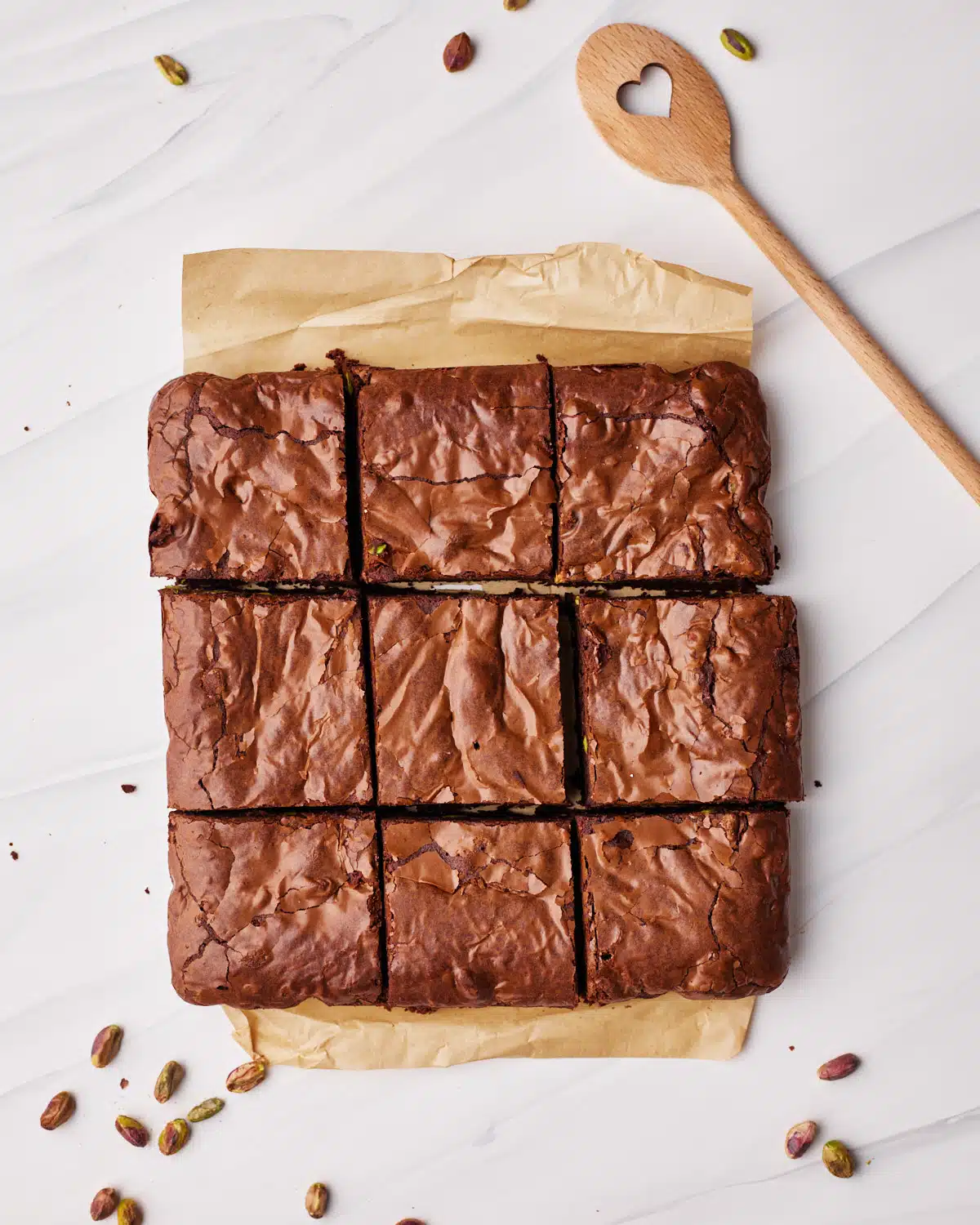 Pistachio brownies sliced into nine squares.