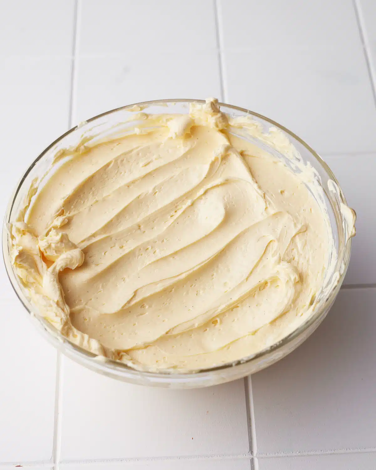 French Buttercream in a glass bowl - thick and glossy.