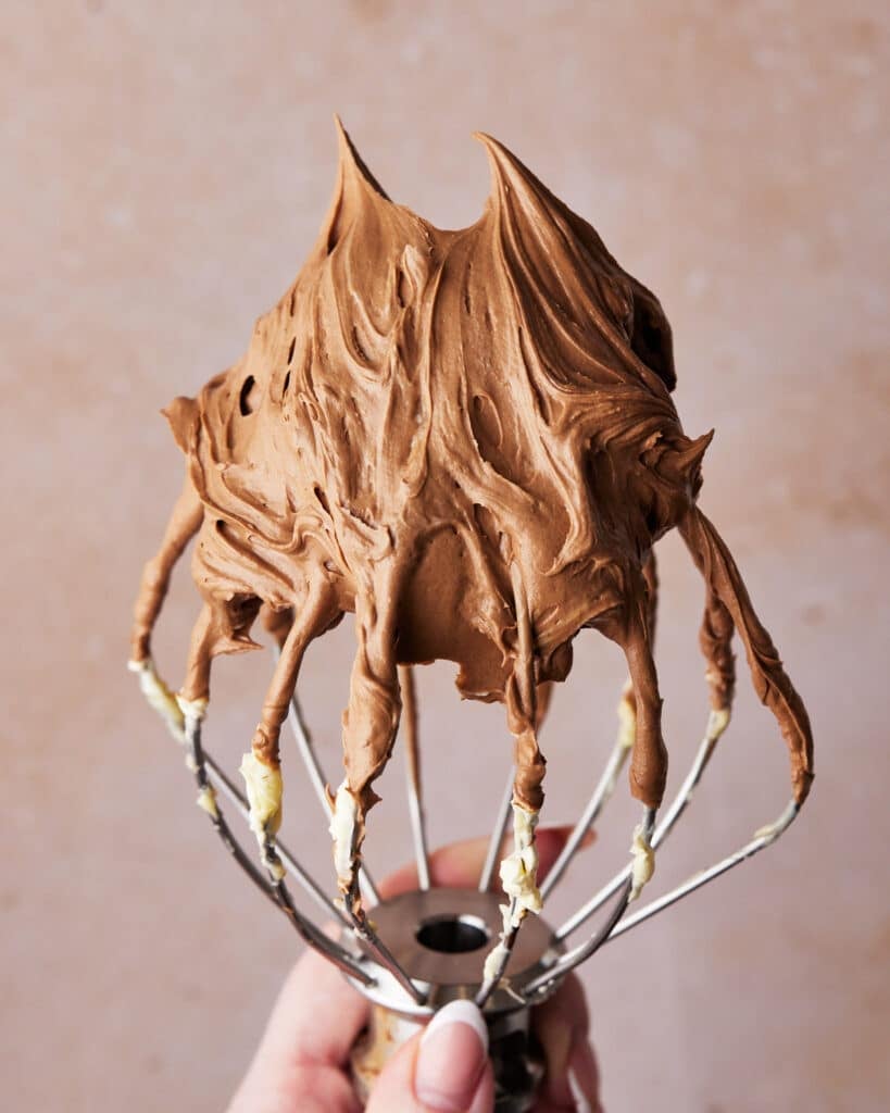 Easy chocolate buttercream frosting on a whisk.