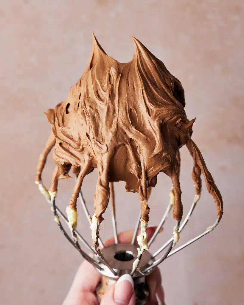 Easy chocolate buttercream frosting on a whisk.