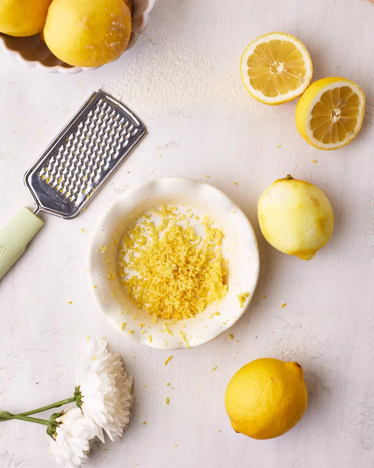 Lemons being zested to make lemon drizzle cake.