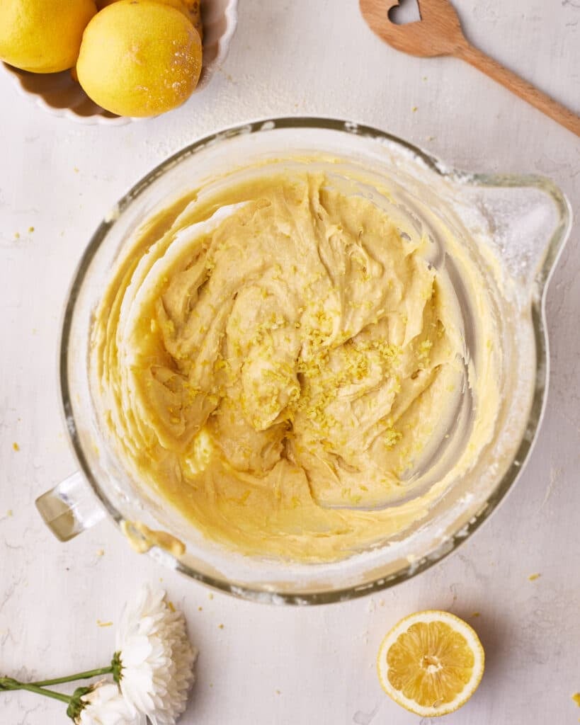 Lemon zest being added to cake batter to make lemon cake.