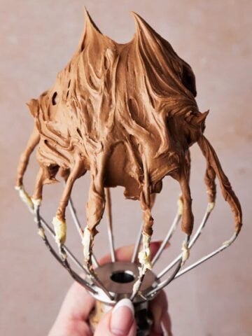 Easy chocolate buttercream frosting on a whisk.