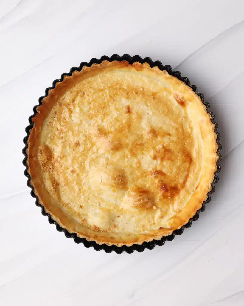 Baked shortcrust tart case in the pan.
