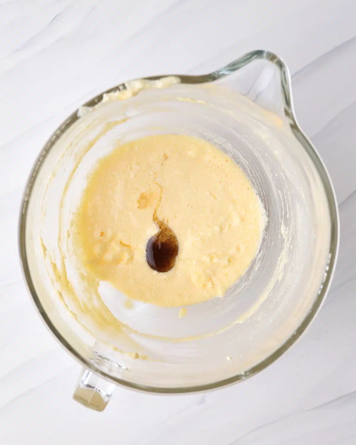 vanilla extract and almond extract being added to frangipane. 