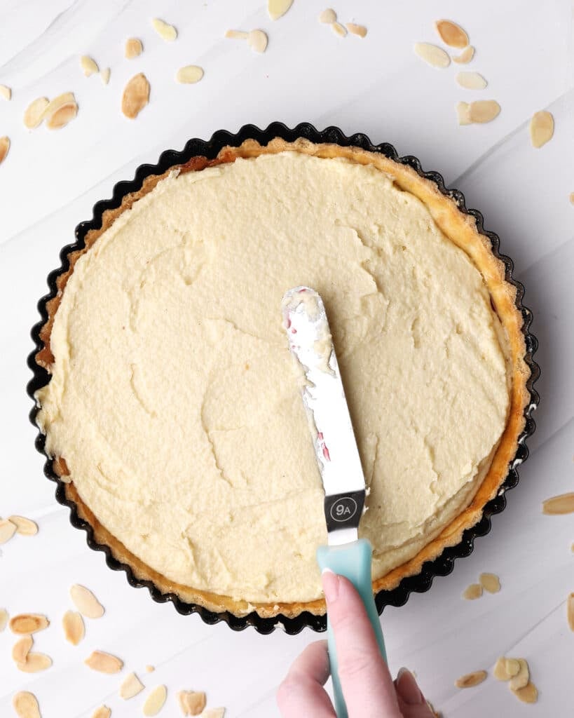 Smoothing out frangipane on top of a bakewell tart. 