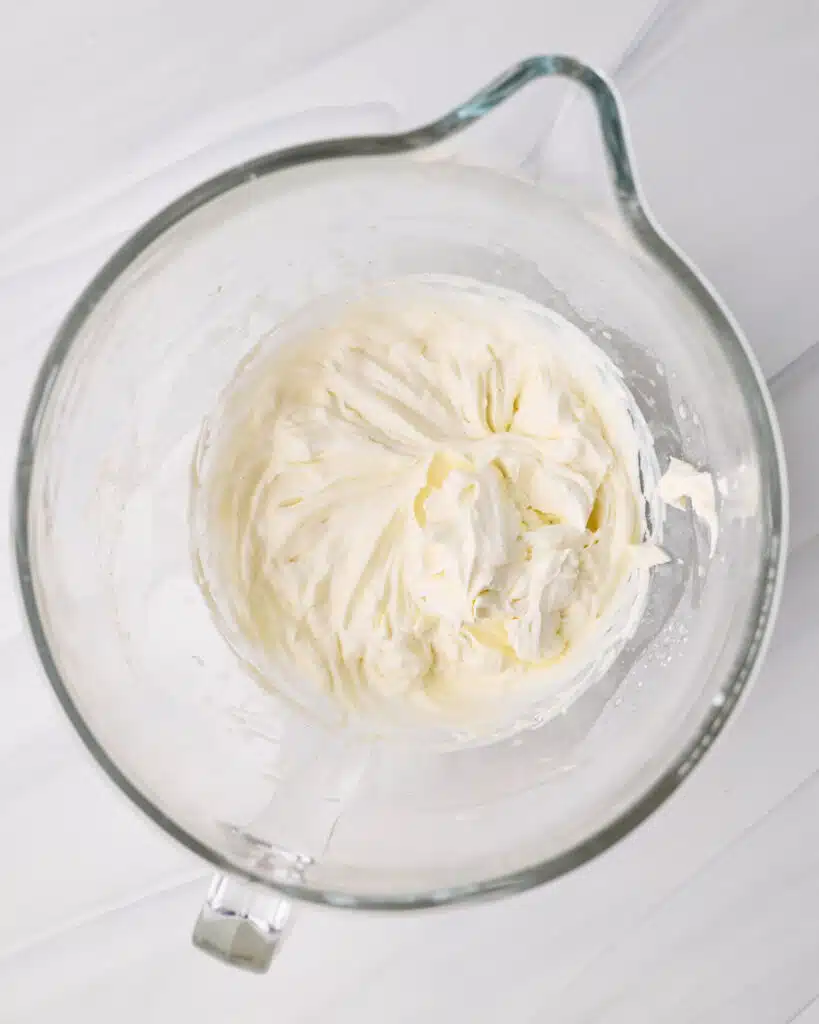 Whipped chantilly cream in a glass bowl.