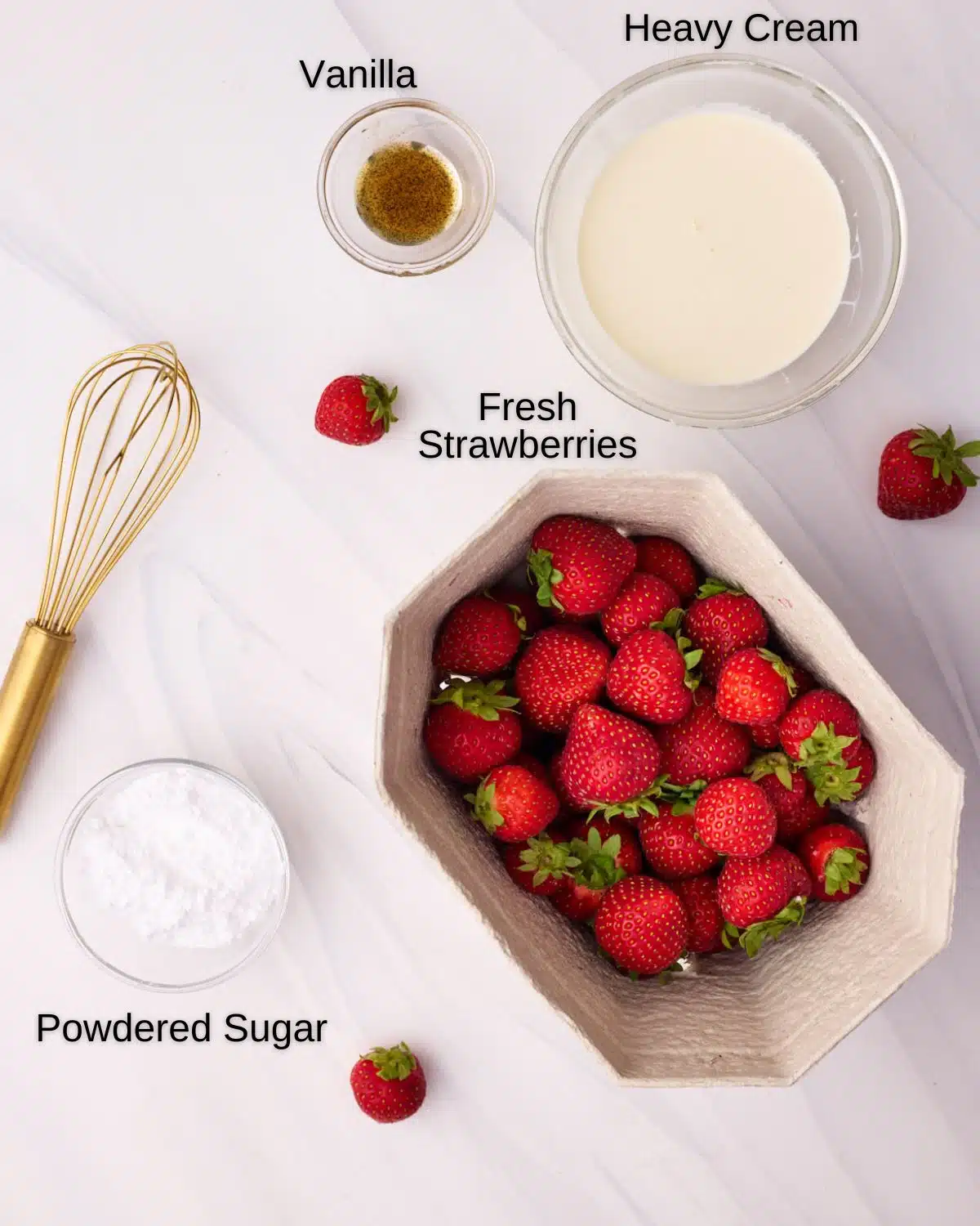 Ingredients to make strawberries and cream, including fresh strawberries, heavy cream, powdered sugar and vanilla bean paste. 