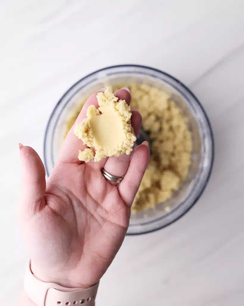 Checking shortcrust pastry to see if it is ready by squeezing the pastry together.