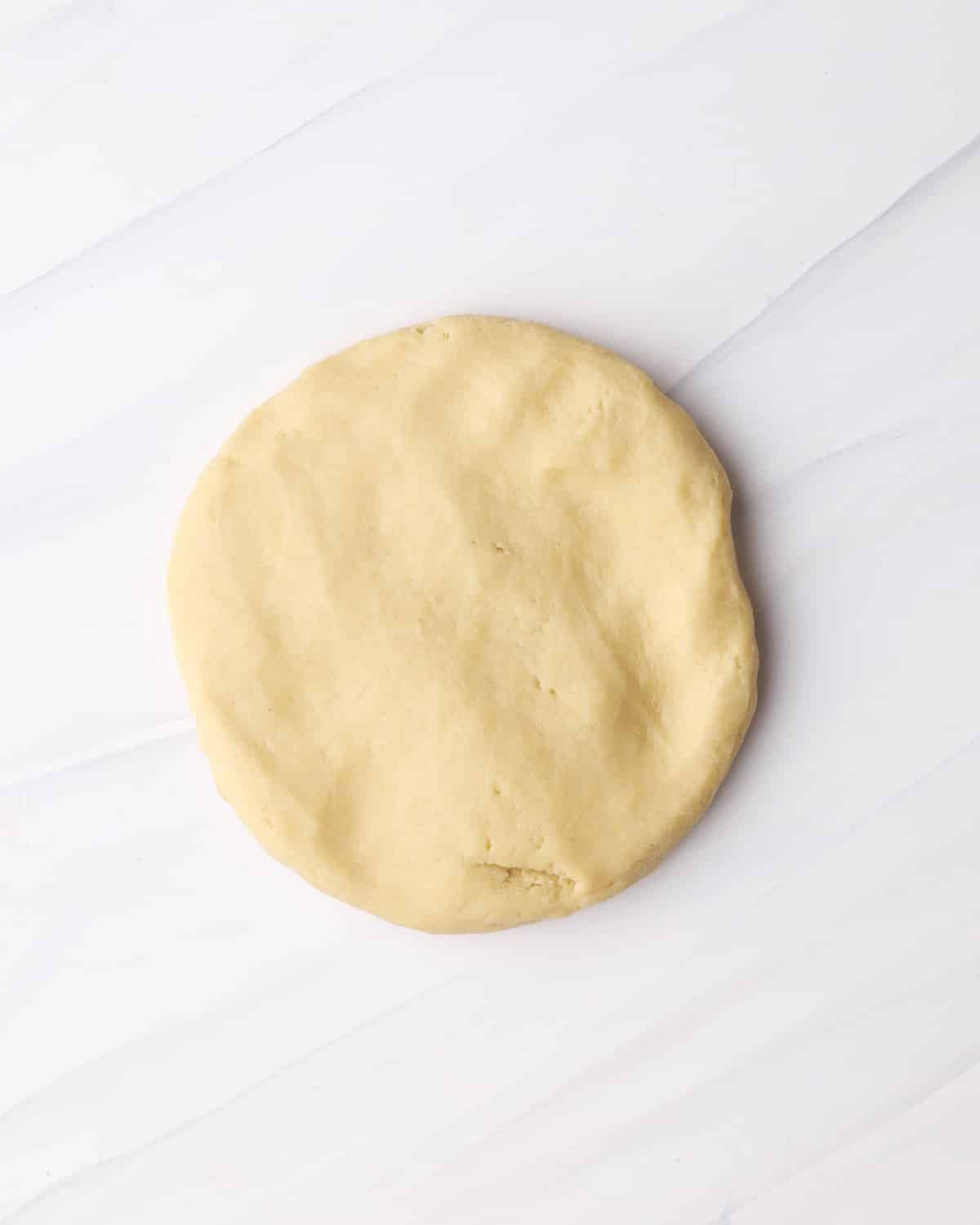 Disk of shortcrust pastry ready to be chilled before making a tart shell.