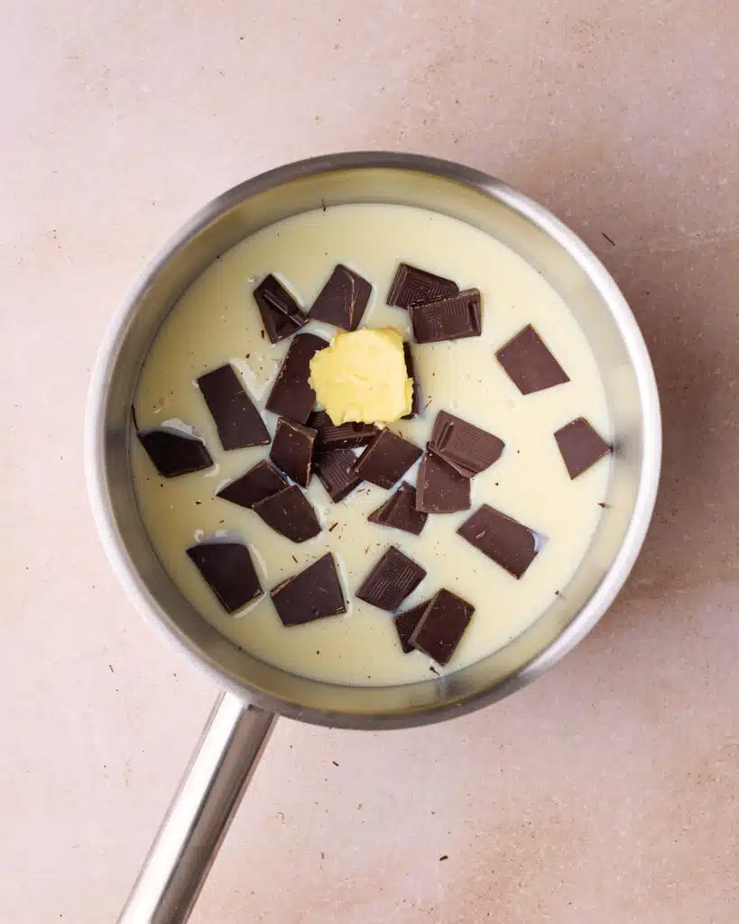 Putting all ingredients to make brigadeiro into a saucepan. 