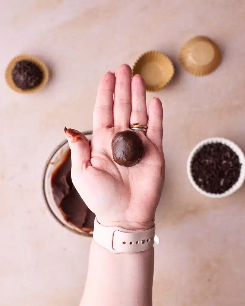 Rolling brigadeiro mixture into small balls. 