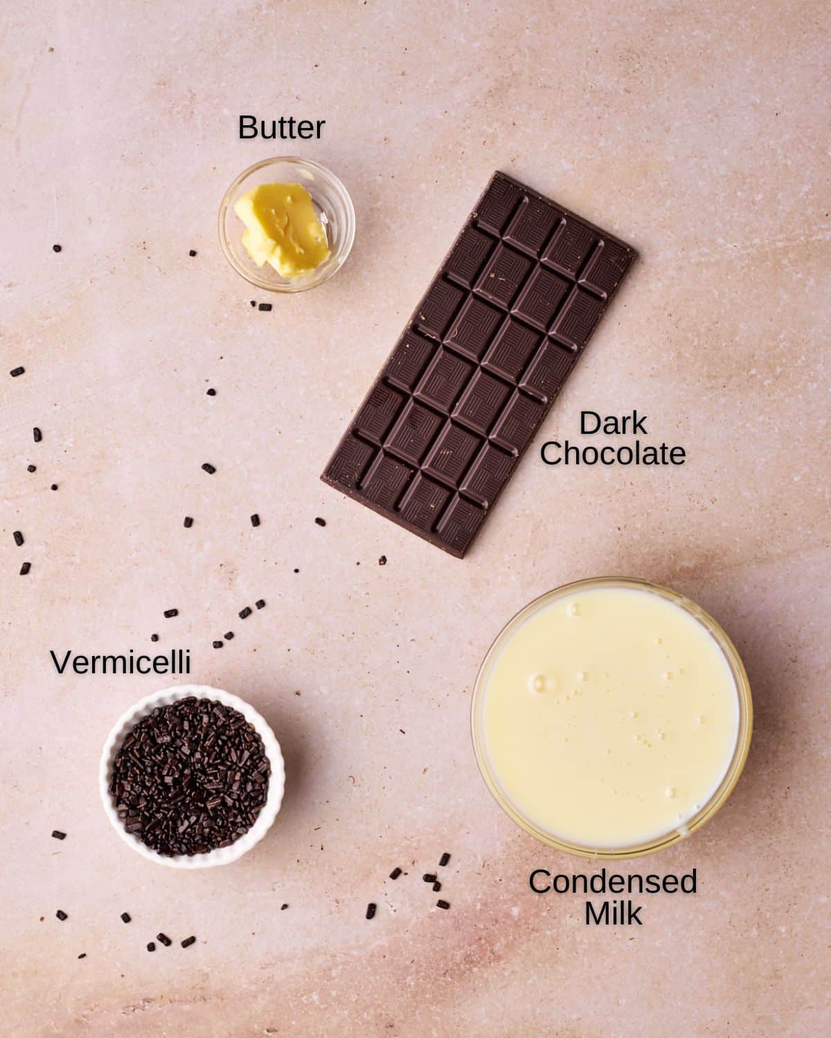 Ingredients to make brigadeiro - condensed milk, dark chocolate, butter and vermicelli.