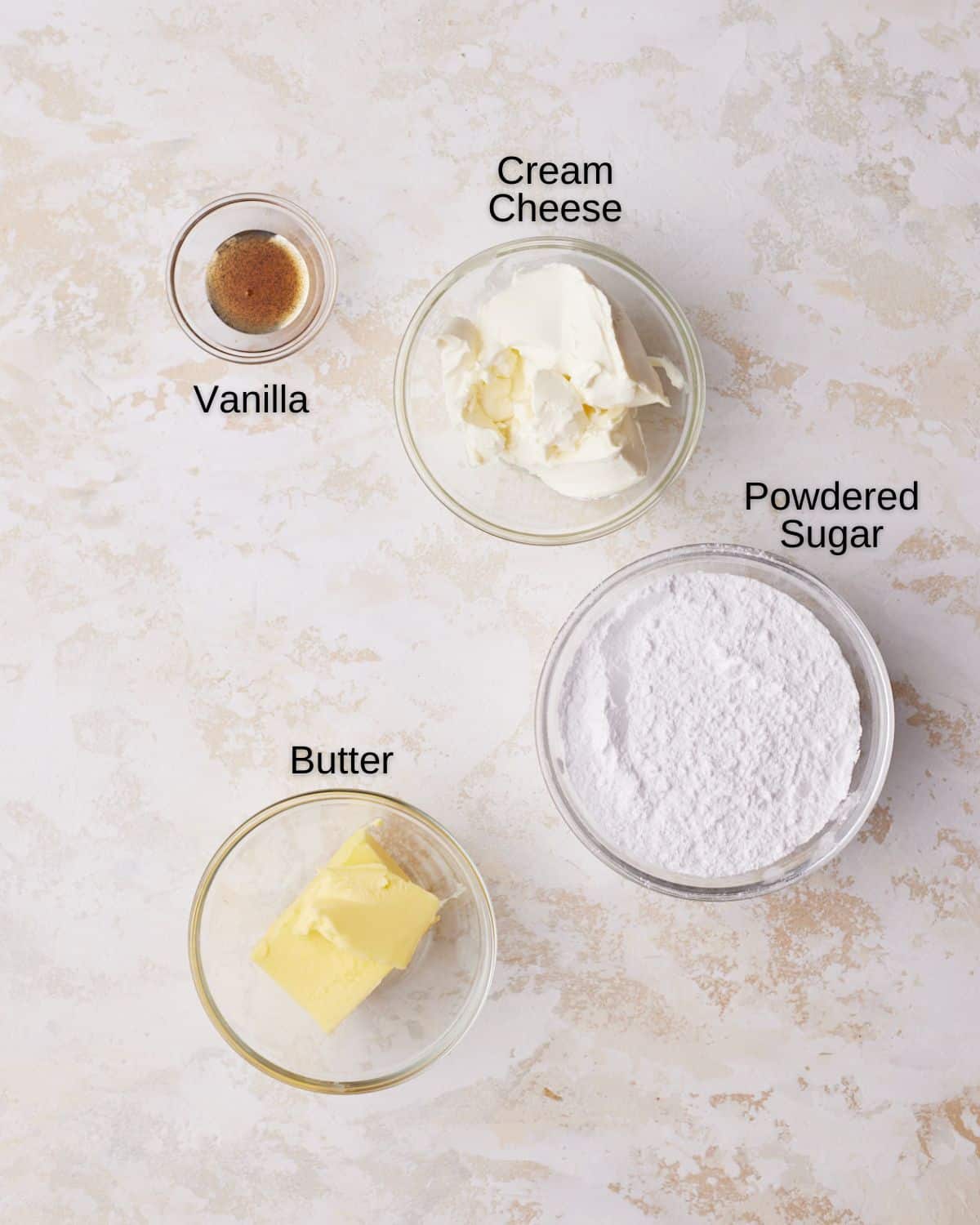 Ingredients to make cream cheese glaze - cream cheese, butter, powdered sugar and vanilla. 