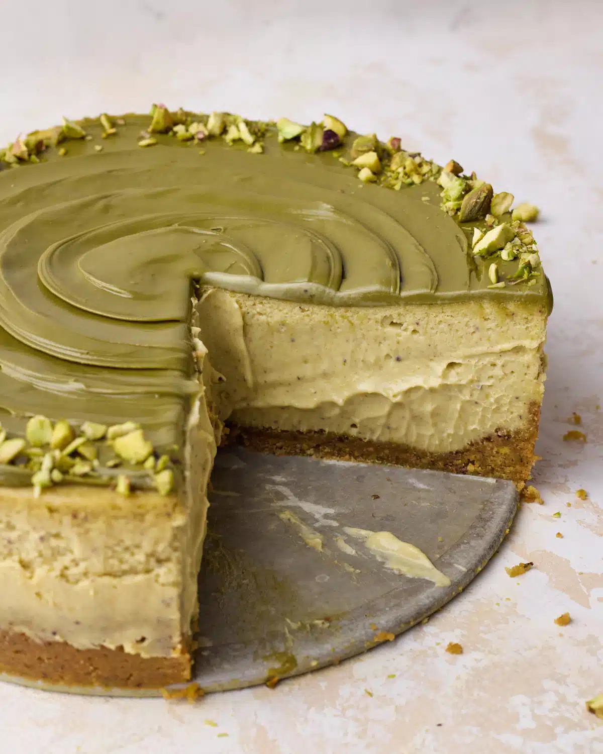 Pistachio cheesecake sliced open to show a super creamy, custardy center. 