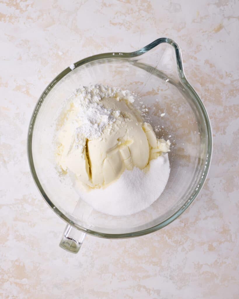 Cream cheese, sugar and cornstarch in a bowl, ready to make cheesecake. 