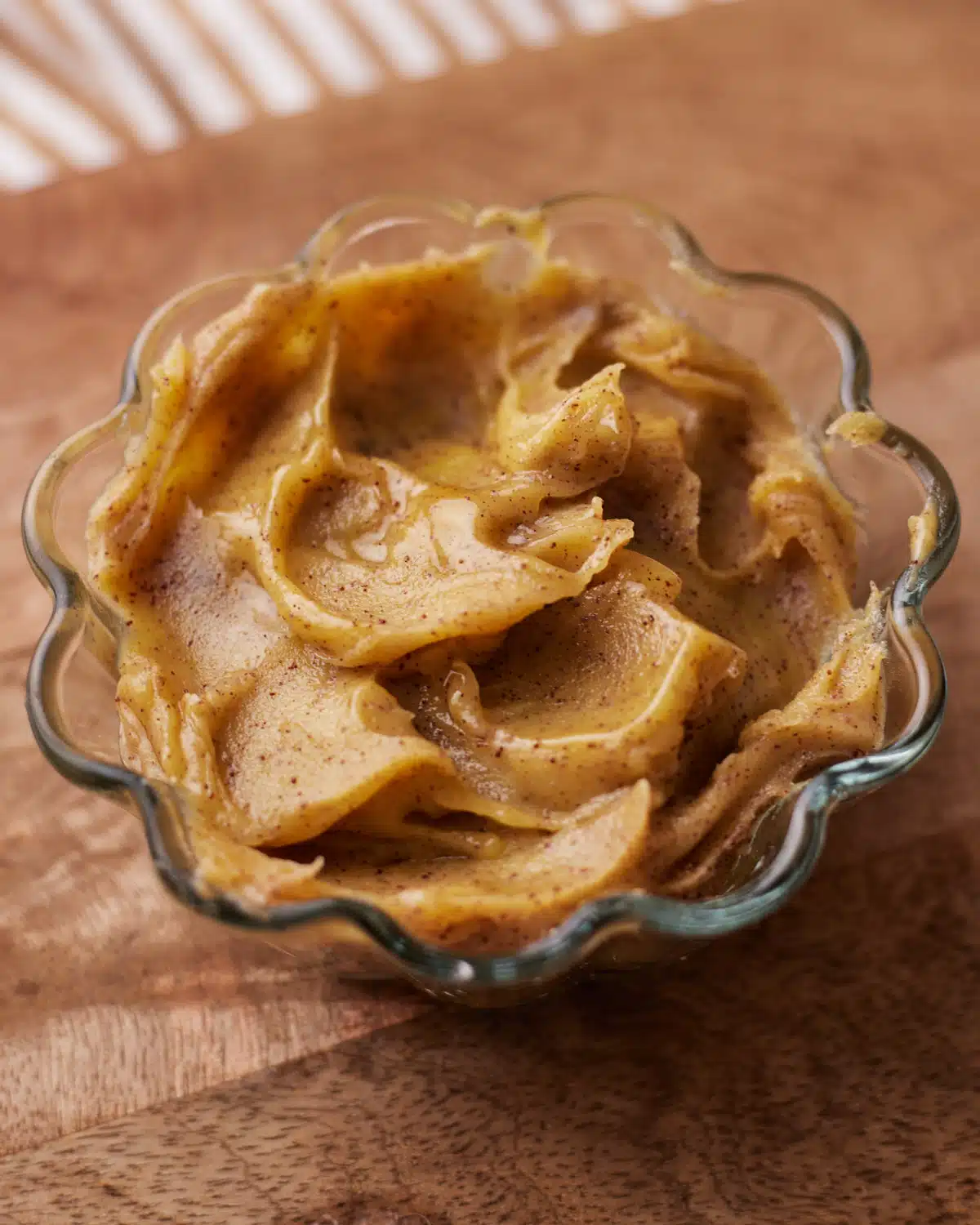Brown butter cooling in a glass dish.