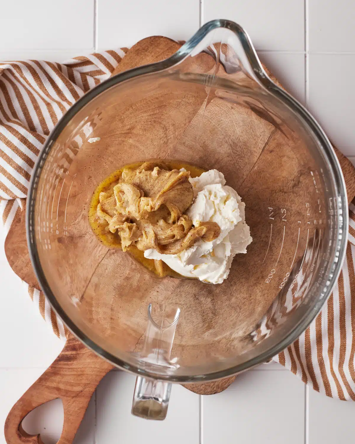 Creaming brown butter and cream cheese together to make brown butter cream cheese frosting.