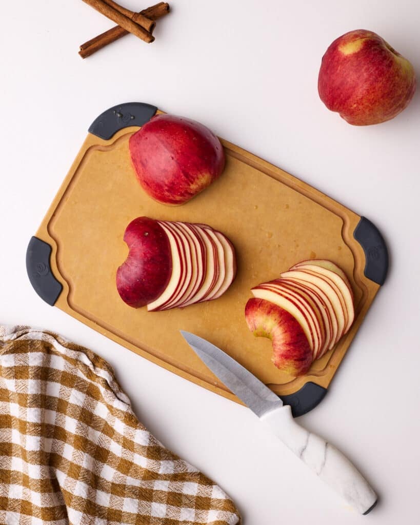 Chopping apples into very thins slices to make apple roses.