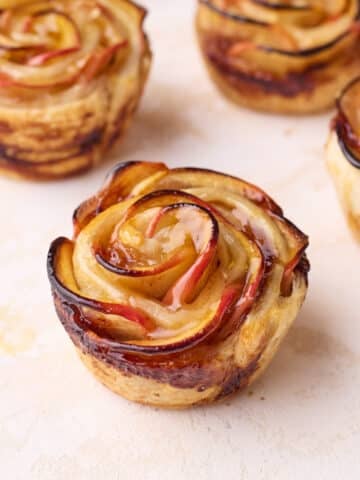 Close up of baked apple roses showing the intricate rose design.