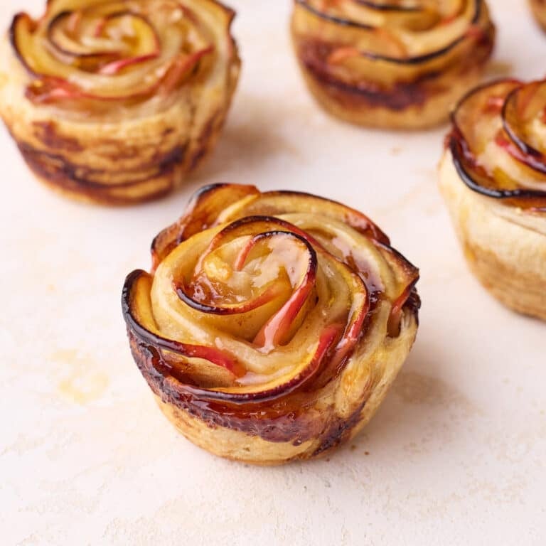 Close up of baked apple roses showing the intricate rose design.