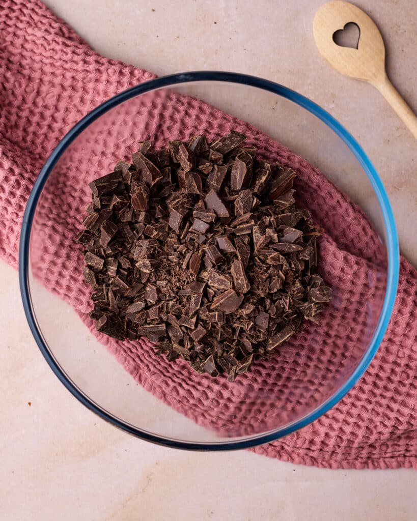 Dark chocolate chopped into small pieces, in a large glass bowl. 