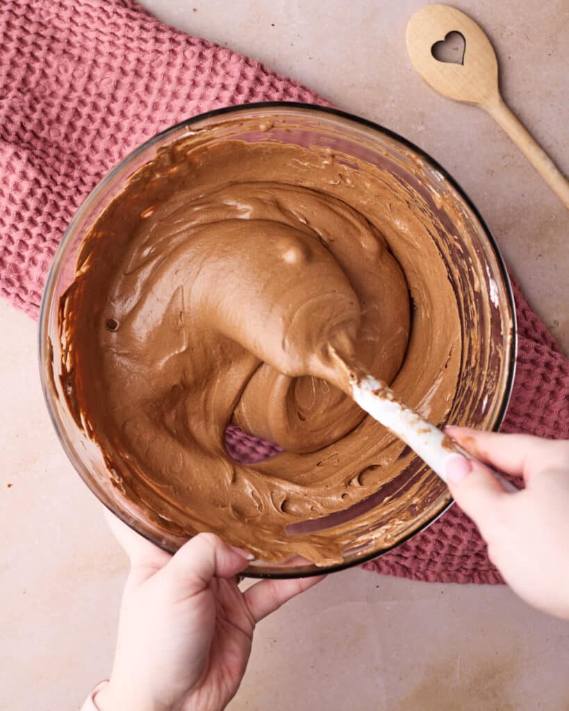 Folding Swiss meringue into chocolate ganache to make chocolate mousse. 