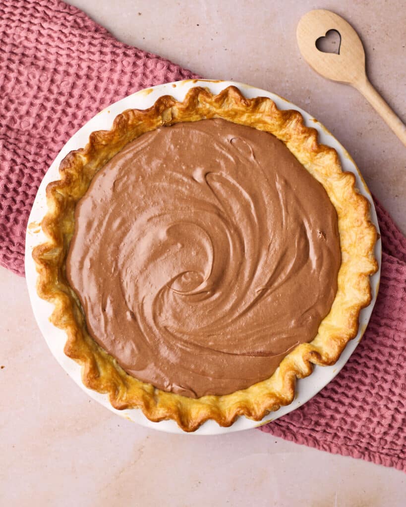 Flaky pie crust filled with chocolate mousse to make chocolate mousse pie. 