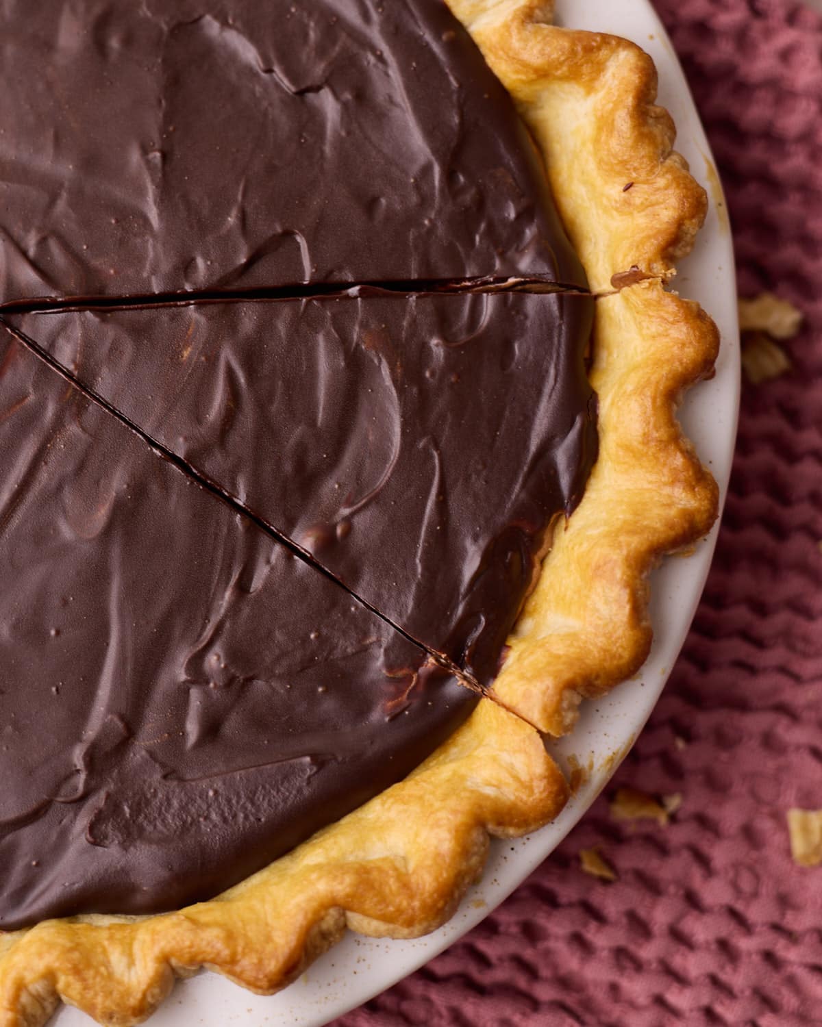 Close up of the golden brown flaky pie crust of a chocolate mousse pie. 