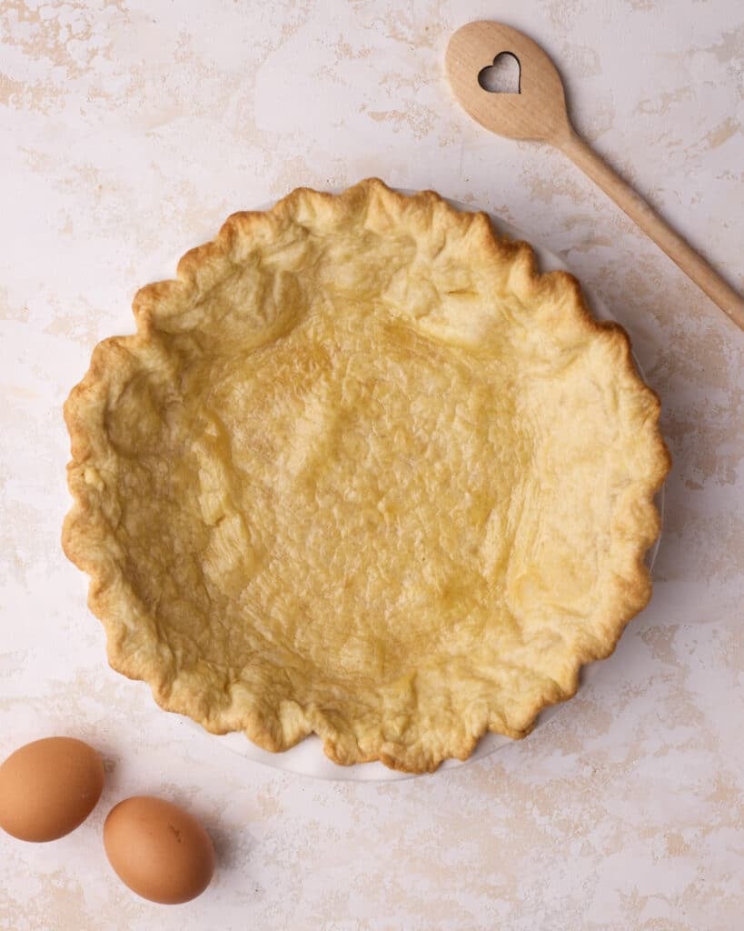 Par-baked homemade flaky pie crust ready to be filled.