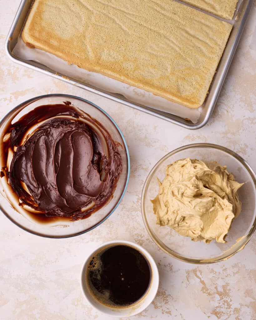 Elements to make French Opera cake - joconde sponge, chocolate ganache, coffee syrup and coffee buttercream. 