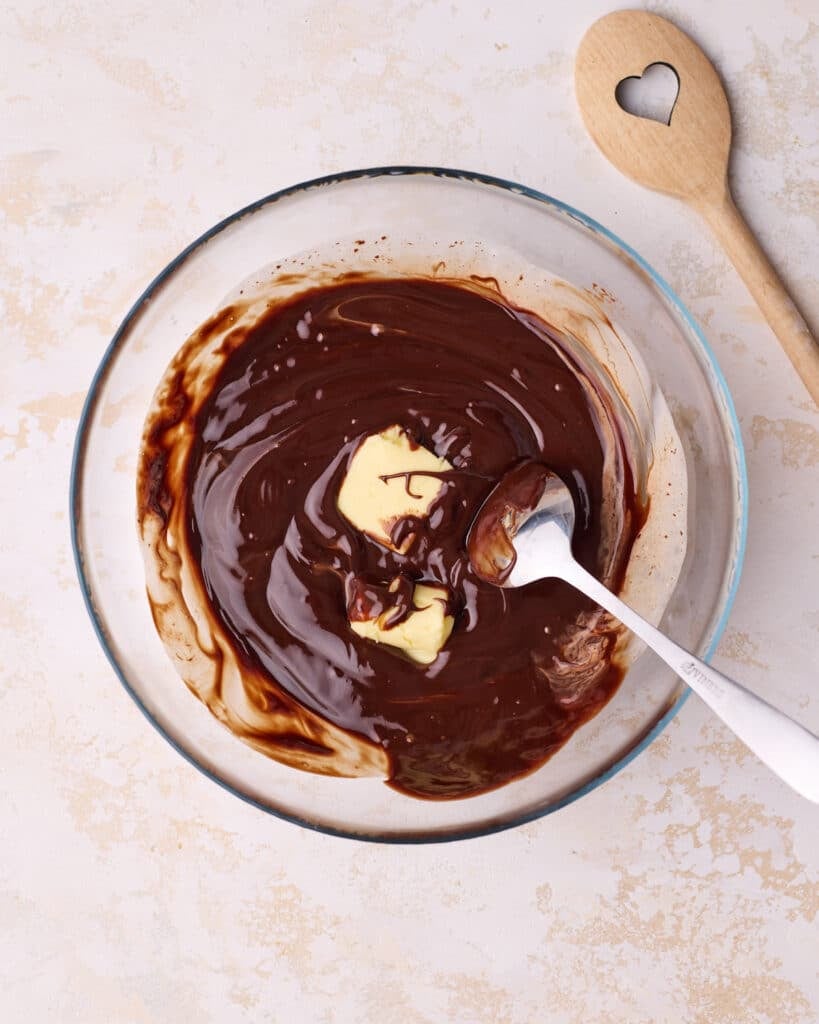 Stirring butter into chocolate ganache. 