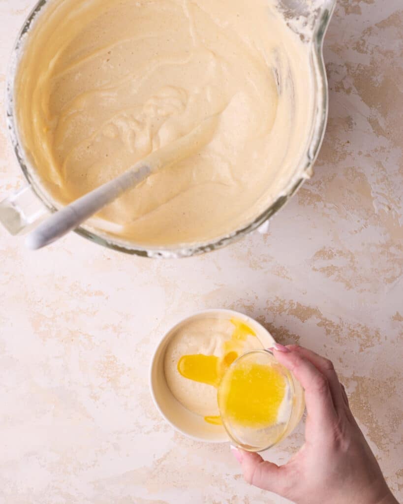 Mixing a small amount of joconde sponge batter into melted butter to 'sacrifice' the batter. 